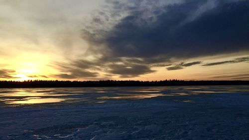 Scenic view of lake against sky during sunset