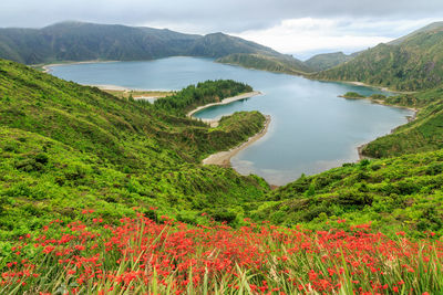 Scenic view of lake and mountains against sky