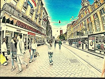 People walking on street against buildings in city