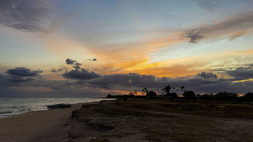 Scenic view of beach against sky during sunset