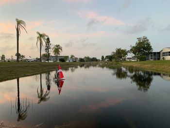 Scenic view of lake against sky at sunset