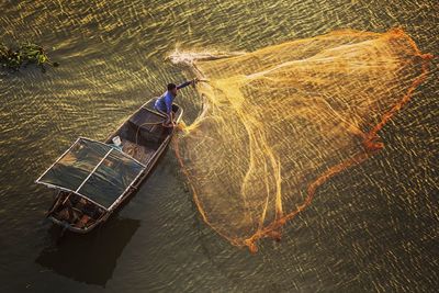 High angle view of man working in sea