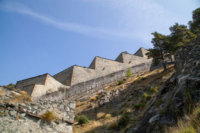 Low angle view of buildings against blue sky