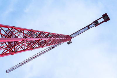 Low angle view of crane against sky