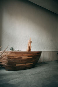 The woman takes a bath at home, only her legs are visible