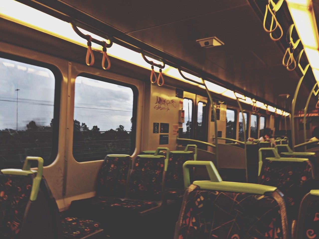 indoors, chair, window, absence, illuminated, empty, table, vehicle interior, restaurant, interior, transportation, glass - material, public transportation, lighting equipment, no people, mode of transport, seat, vehicle seat, transparent, built structure