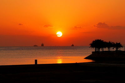 Scenic view of sea against orange sky