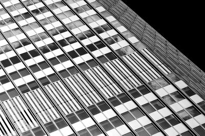 Low angle view of modern building against sky at night