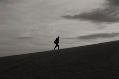 Man on beach against sky