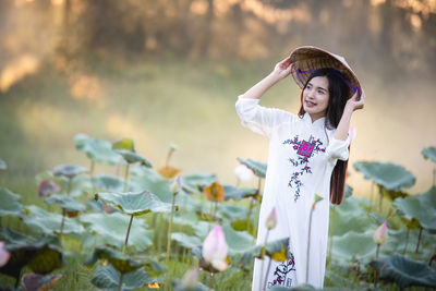 Young woman standing on field