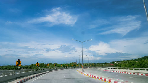 Empty highway against blue sky