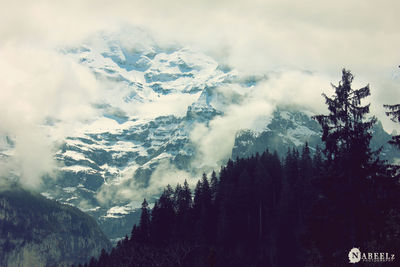 Scenic view of snow covered mountains against sky