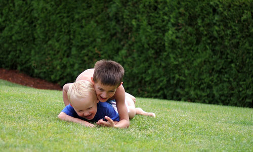 Full length of girl playing on grassy field