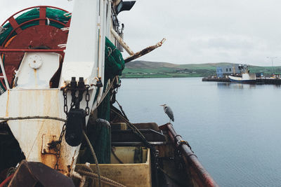 Boats moored on sea against sky