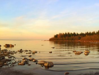 Scenic view of lake against sky during sunset