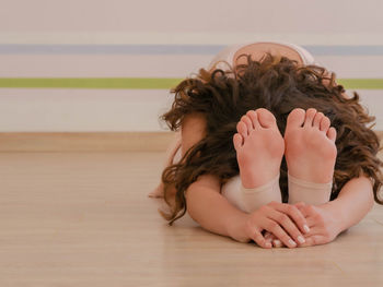 Young woman exercising on floor