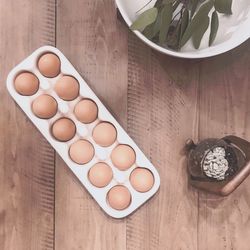 Fresh brown eggs in ceramic carton