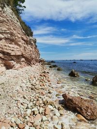 Rocks on beach against sky