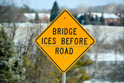 Close-up of road sign against trees