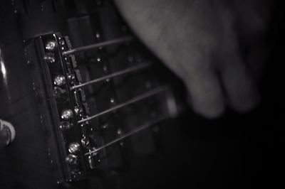 Close-up of hands playing guitar