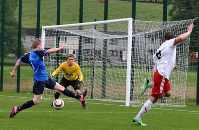 People playing soccer ball on field