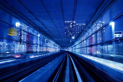 View of railroad tracks in city at night