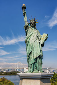 Statue of liberty against sky in city