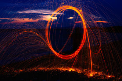 Light trails against sky at night