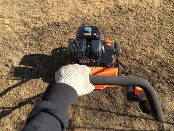 High angle view of person hand on road