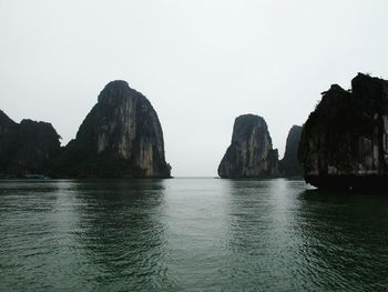 Panoramic view of sea and mountains against clear sky