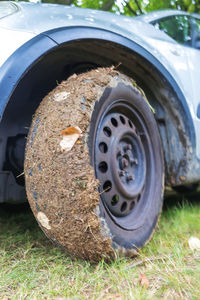 Close-up of abandoned car on field