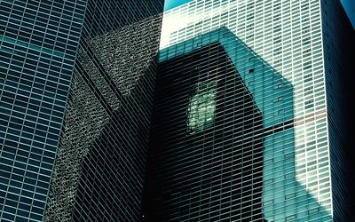 Low angle view of modern glass building in city