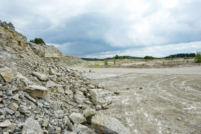 Open-pit mine against cloudy sky