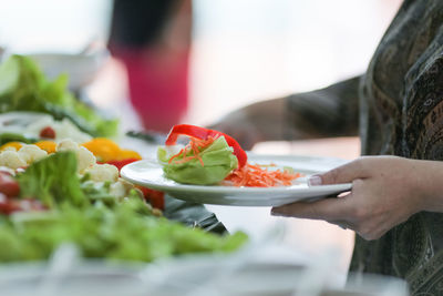 Midsection of woman having food