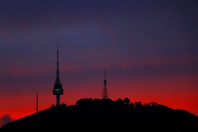 Silhouette of communications tower in city