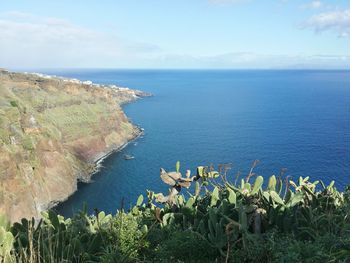 Scenic view of calm sea against cloudy sky