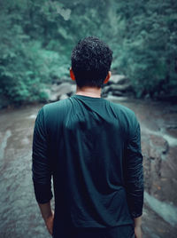 Rear view of man looking at forest