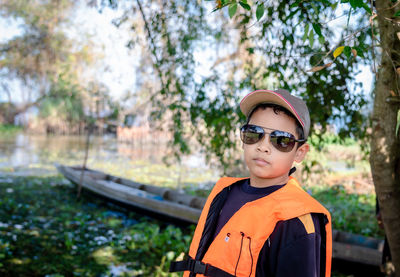 Asian tourists boy wear life jackets and are ready to travel abroad.