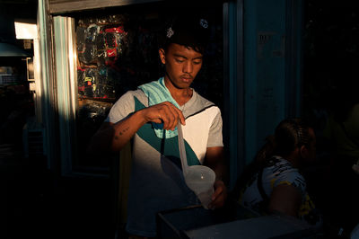 Young man sitting on chair at restaurant