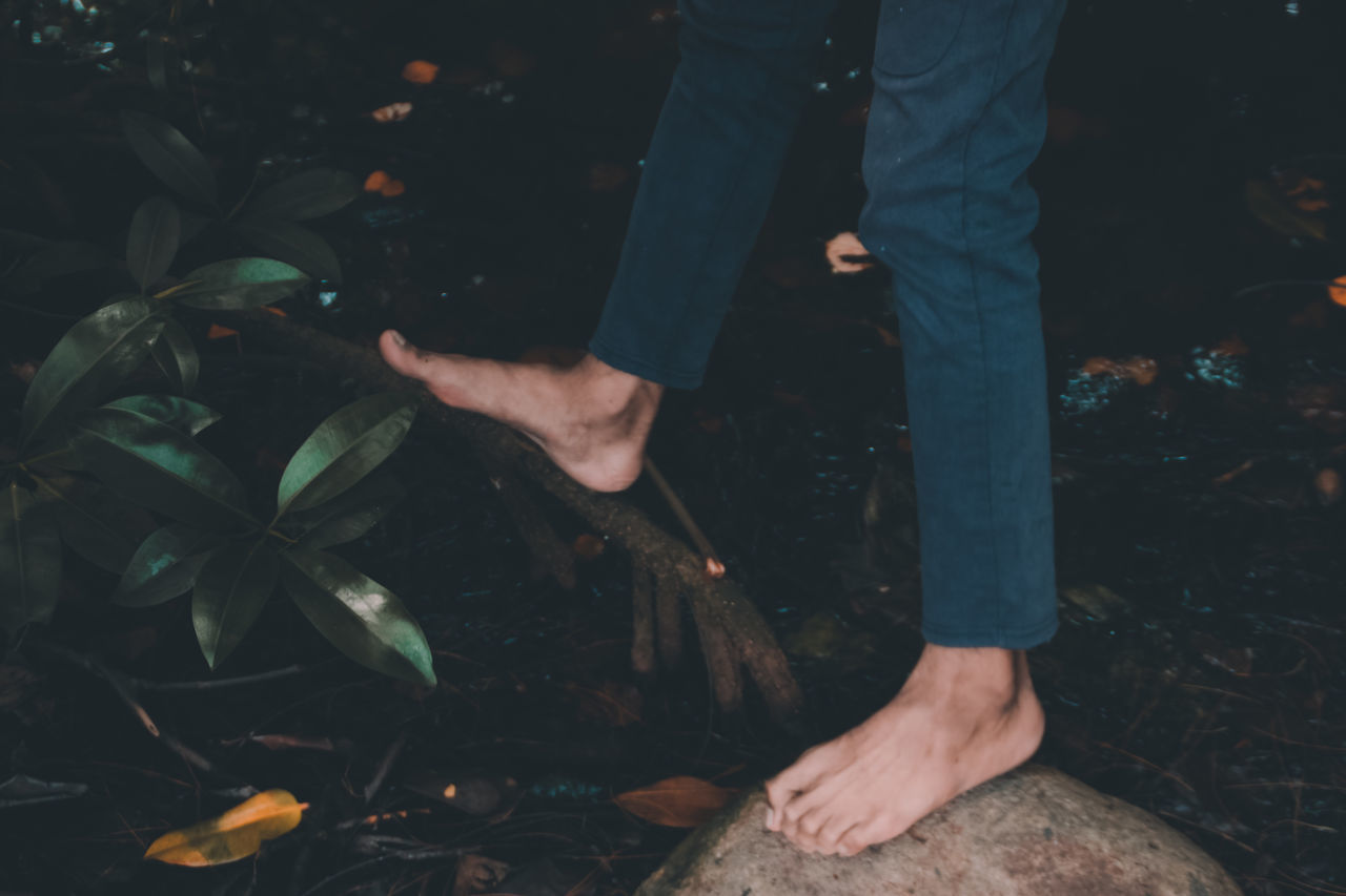 LOW SECTION OF MAN STANDING ON LAND