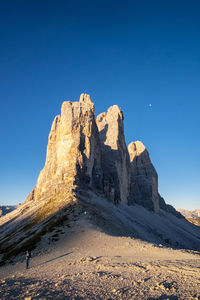 Rock formations against clear blue sky