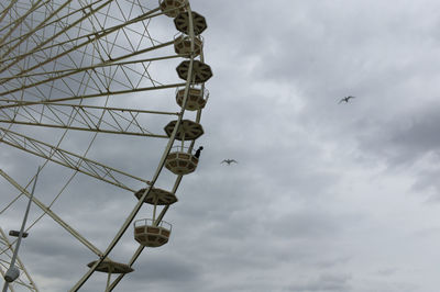 Low angle view of ferris wheel against sky