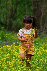 Full length of cute girl standing on field