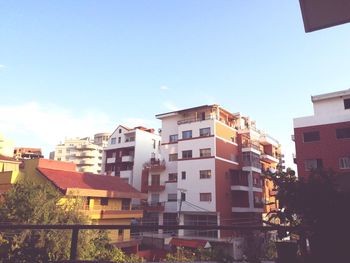 Low angle view of buildings against blue sky