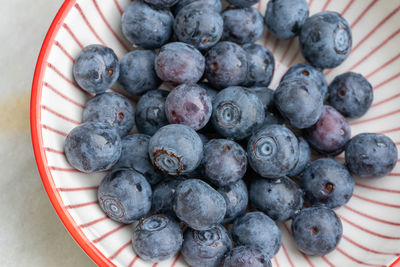 High angle view of blueberries in bowl on table