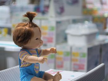 Portrait of cute girl sitting on table