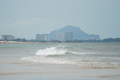 Scenic view of sea and buildings against sky