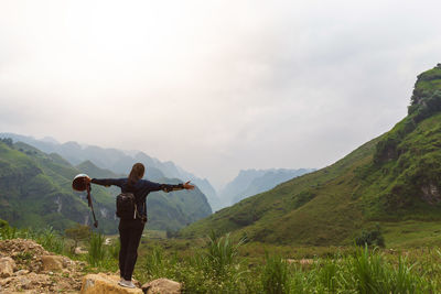 Full length of man standing on mountain against sky