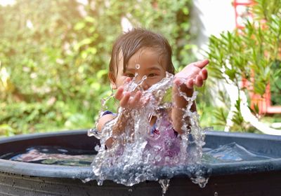 Portrait of boy sitting in water