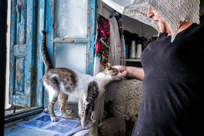 Full length of man and cat